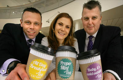 Holding coffee cups up to the camera